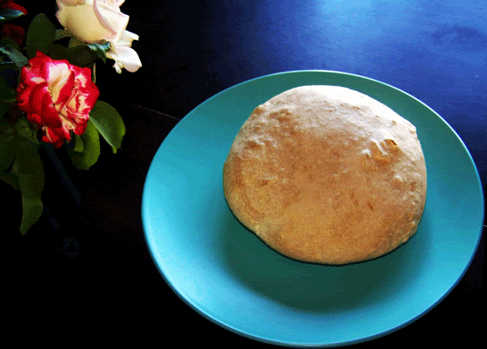 Large bread on a blue plate.