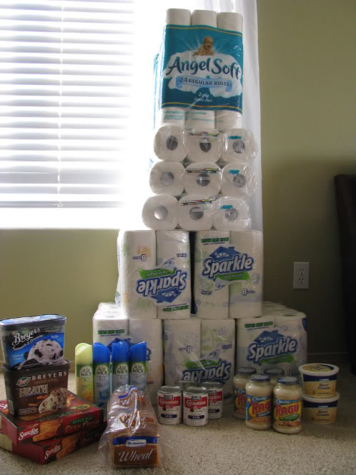 Groceries, including a stack of toilet paper and paper towels.