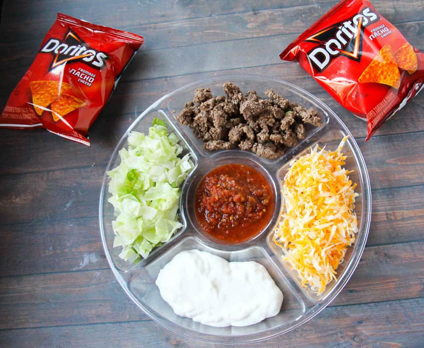 This is by far the dinner my kids request the most due to the fun factor - Doritos Taco Salad Recipe in a Bag! Doritos, taco meat, & cheese = perfection. happymoneysaver.com