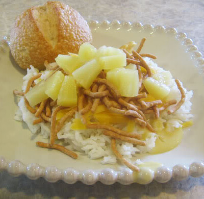 Hawaiian haystacks on a plate with a roll.