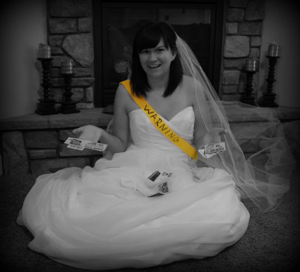 Woman sitting in a wedding dress with a yellow warning sash across her front.