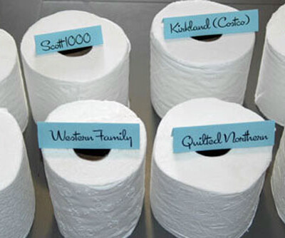 Rolls of toilet paper labeled with their brand including Kirkland and Quilted Northern.