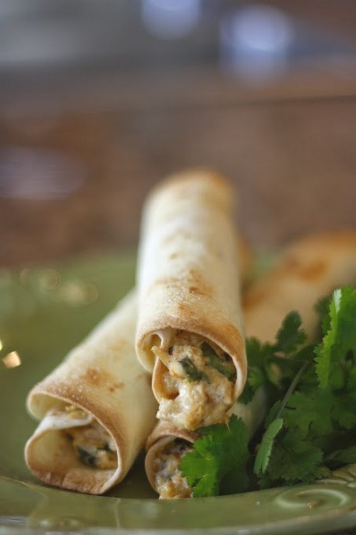 Easy and Delicious Homemade Crispy Chicken Taquitos with cream cheese, cilantro and pepper-jack cheese. Best chicken taquitos recipe pinterest has!