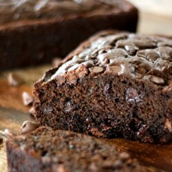 Partially-sliced loaf of triple chocolate zucchini bread.