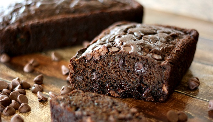 Partially-sliced loaf of triple chocolate zucchini bread.