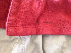 Sewing needle in a red shirt.
