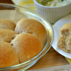 Glass bowl of whole wheat rolls.