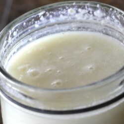Open glass jar of buttermilk.