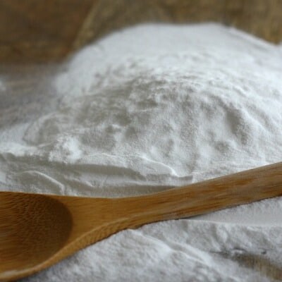 Wooden spoon on a pile of baking soda.