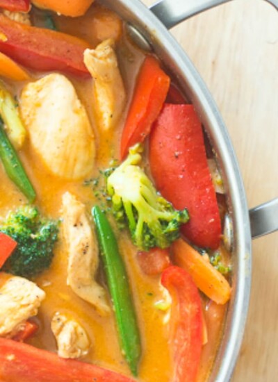 Red coconut curry chicken in a pot.