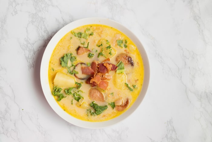 Zuppa Toscana Soup copycat version from Olive Garden in a white bowl on a marble background