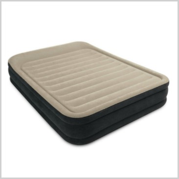 A queen inflatable bed with light brown  on top.