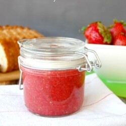 Chia seed strawberry jam in a glass jar.