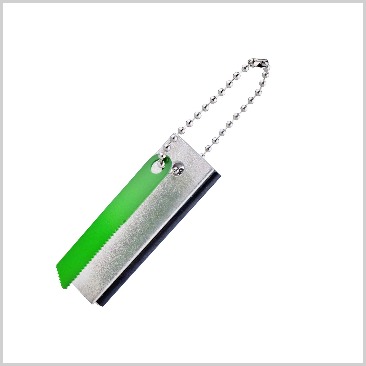 A magnesium fire starter on a keychain with a green stick.