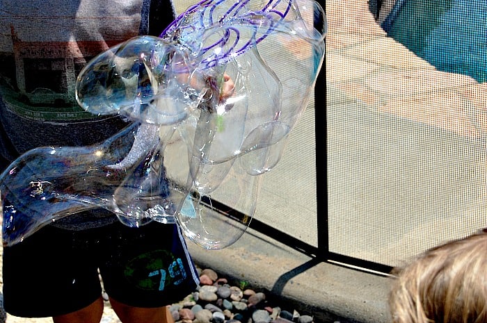 I love this homemade soap bubble recipe because the ingredients are so simple! My kids had hour of fun making huge bubbles that took forever to pop! | Happymoneysaver.com