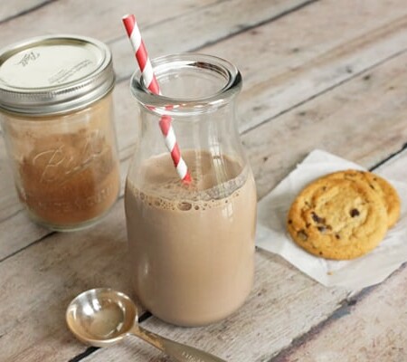 Glass of DIY Nesquik with a red and white straw.