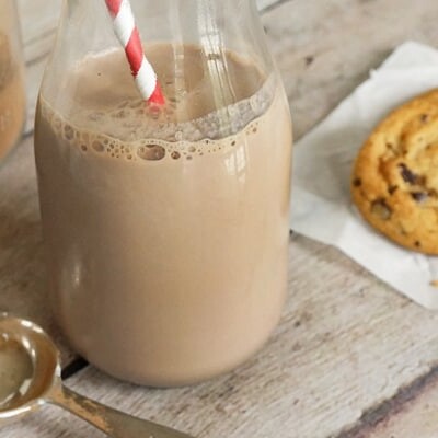 Glass of DIY Nesquik with a red and white straw.