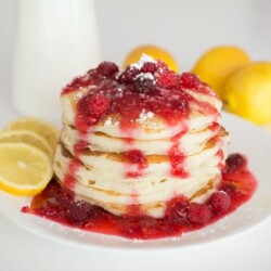 Stack of lemon pancakes topped with fruit.