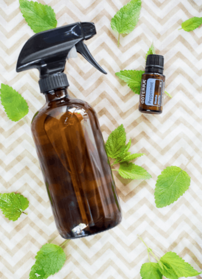 Spray bottle with a bottle of doTerra peppermint essential oil.