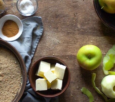 Apple brown Betty ingredients on a wooden table.