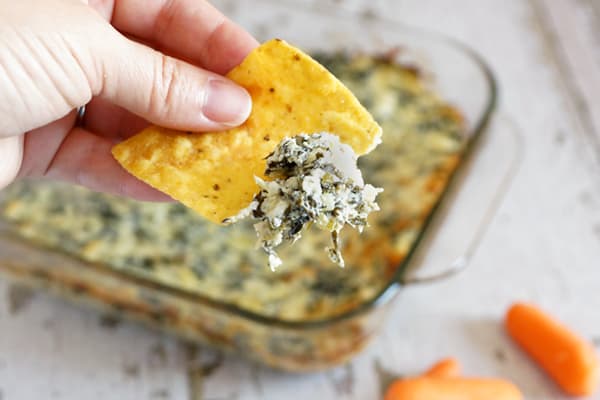 You've got to try this Easy Spinach Artichoke Dip...it's sure to be a big hit at your next get together! So easy to make and freezes well! Everyone will be asking for the recipe! | happymoneysaver.com