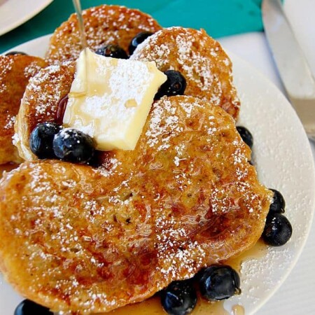 Vanilla orange custard French toast topped with butter and syrup.