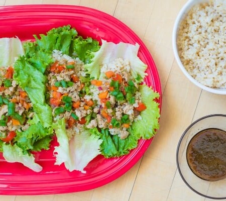 Asian lettuce wraps on a red platter.