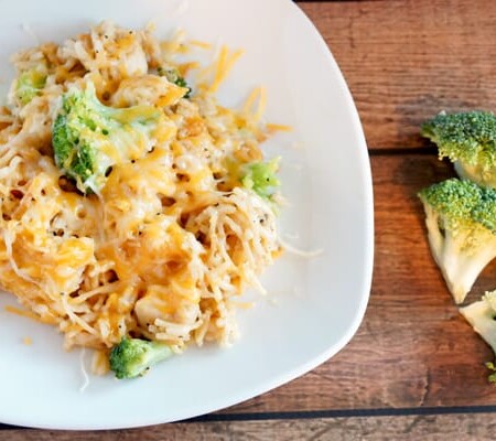 Cheesy chicken broccoli rice casserole on a white plate.