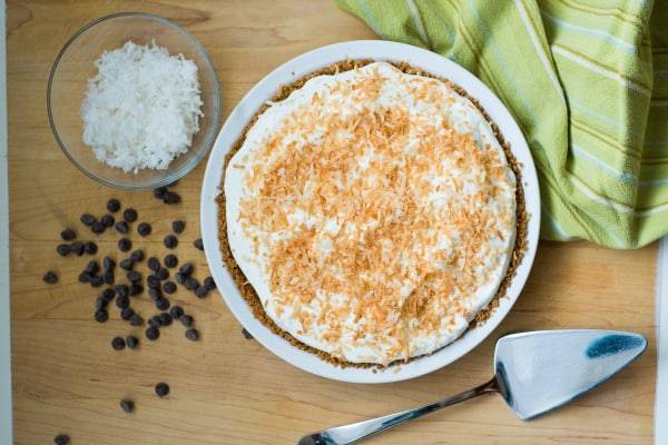 The smooth coconut custard and sweet chocolate ganache are sure to make all of your Chocolate Coconut Pie dreams come true! Straight forward and easy recipe. | happymoneysaver.com