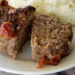 Slices of mini meatloaf on a plate with mashed potatoes.