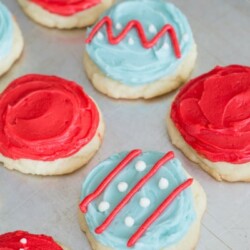 Sugar cookies decorated with blue, red, and white frosting.