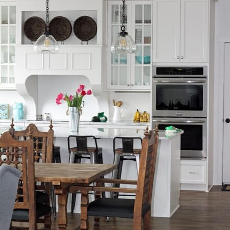 Clean kitchen with a vase of flowers.