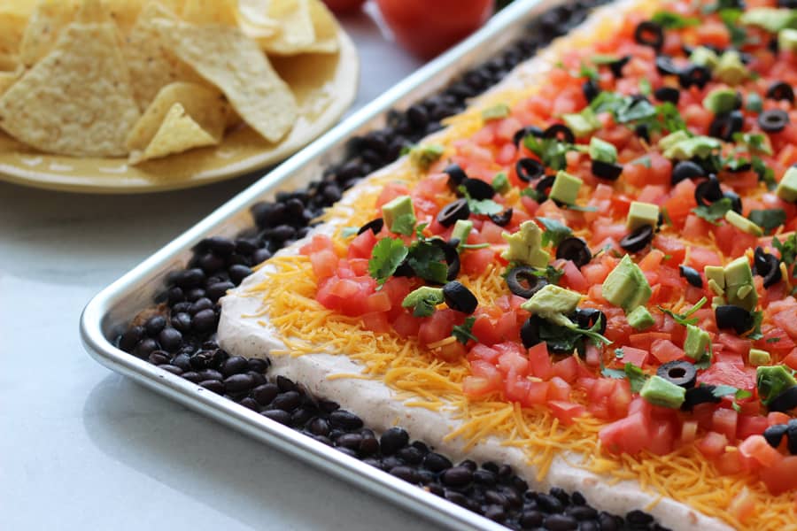 This simple and easy Tex Mex Dip recipe is not only delicious but BEAUTIFUL too! Includes 7 layers of awesome and can feed a large crowd. Tex-Mex Dip Recipe from HappyMoneySaver.com