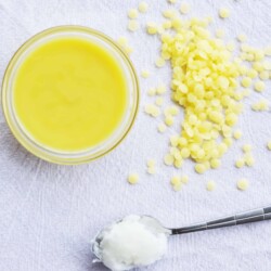 Jar of bright yellow allergy relief balm.