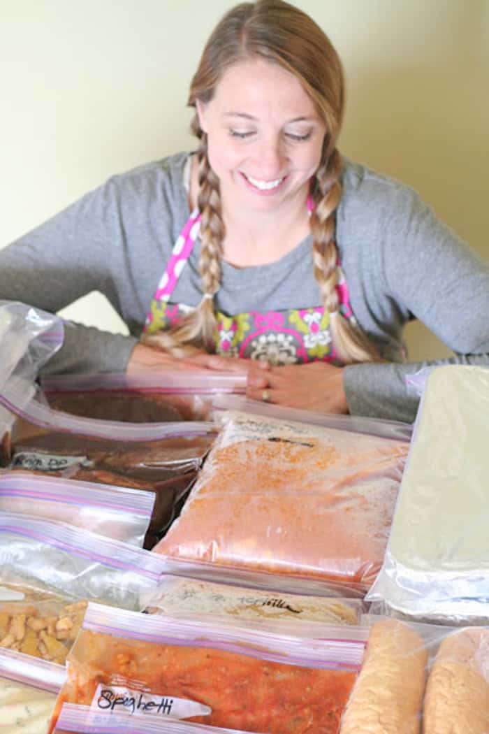 Karrie smiling looking at bags of food.