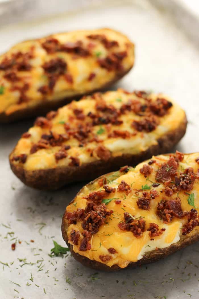 Line of loaded baked potatoes.