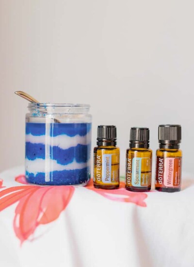 Bottles of doTerra essential oils with a jar of blue and white sugar scrub.
