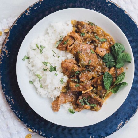 Spicy pepper beef on a plate with rice.