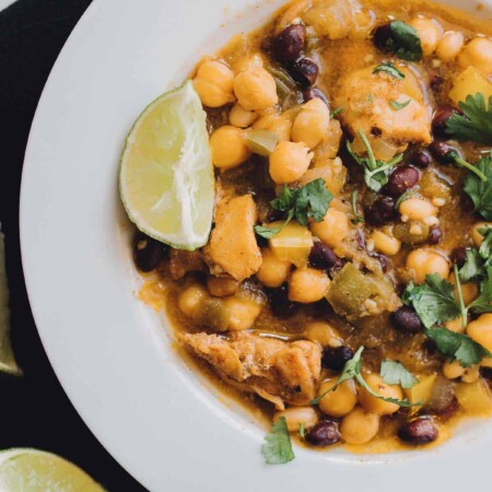 Bowl of red and white chili with a lime wedge.