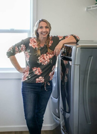 Karrie leaning with her arm on her Maytag dryer.