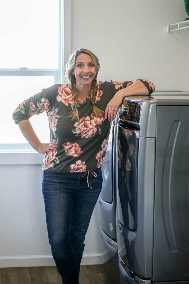 Karrie leaning with her arm on her Maytag dryer.