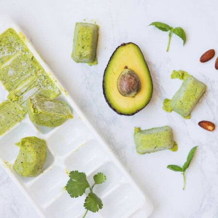 ice cube tray with avocado pesto in it