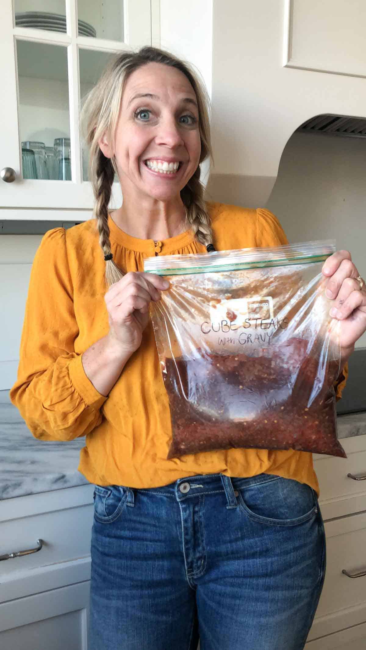 Best list of easy freezer meals: karrie truman holding a bagged freezer meal