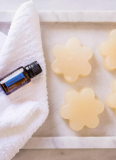 Flower-shaped shower jellies next to a bottle of doTerra peppermint essential oil.