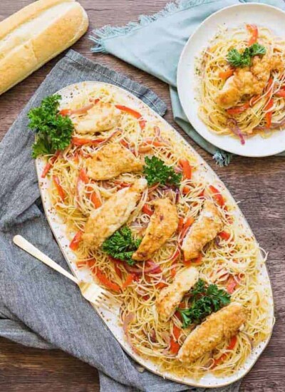 This chicken scampi recipe is to die for. Angel hair pasta covered in a creamy garlic sauce with caramelized onions and bell peppers & topped with chicken.