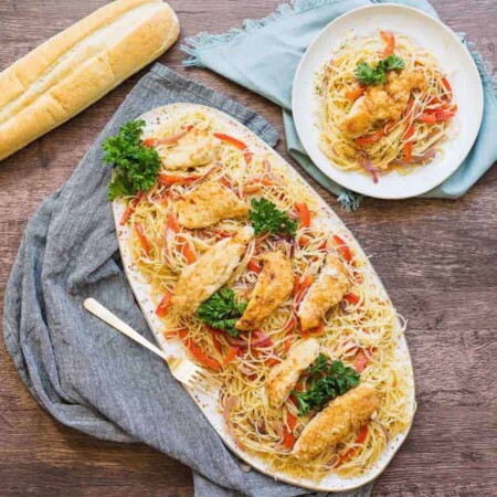 This chicken scampi recipe is to die for. Angel hair pasta covered in a creamy garlic sauce with caramelized onions and bell peppers & topped with chicken.