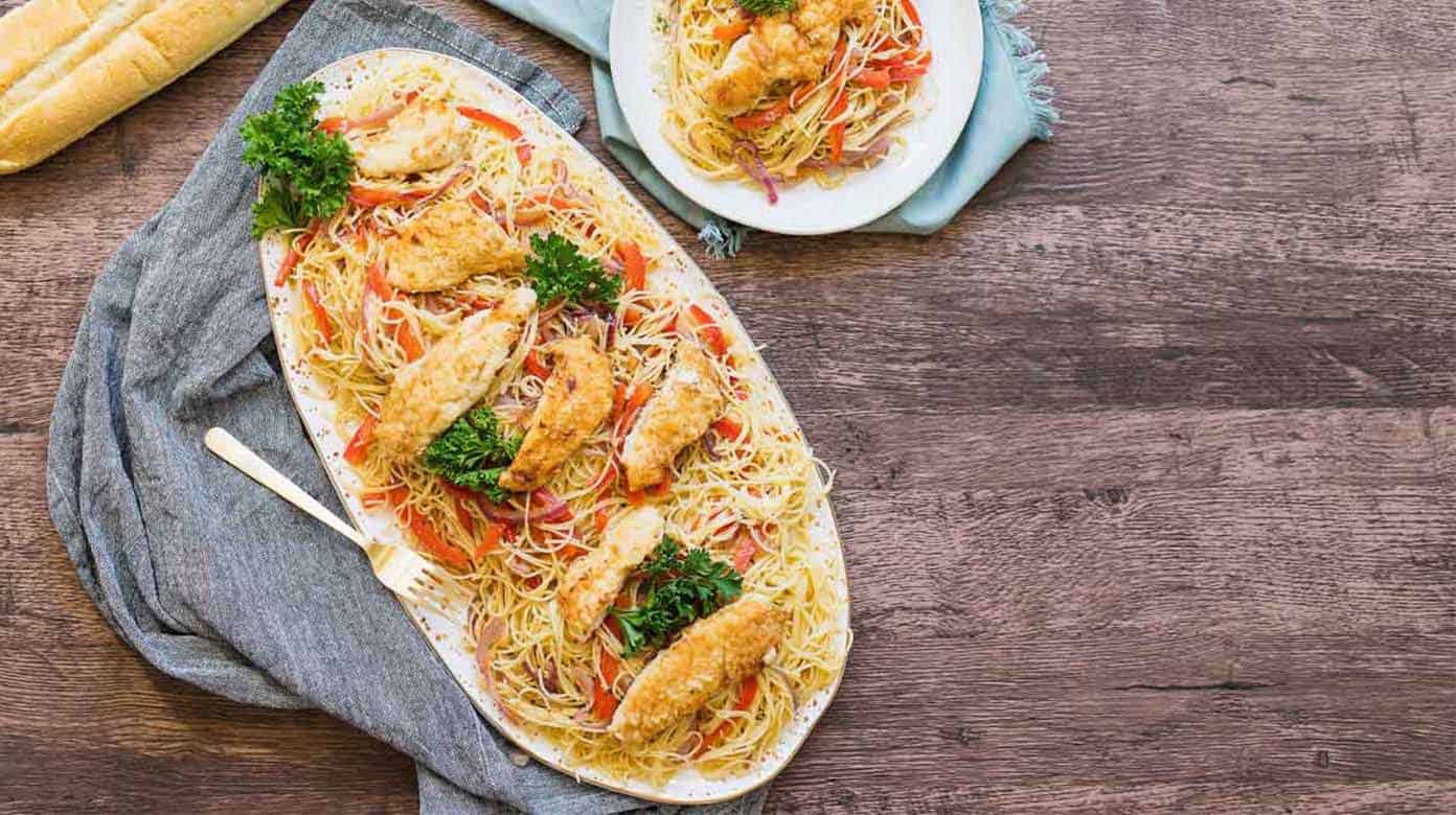 Chicken Scampi with angel hair served on a serving dish.