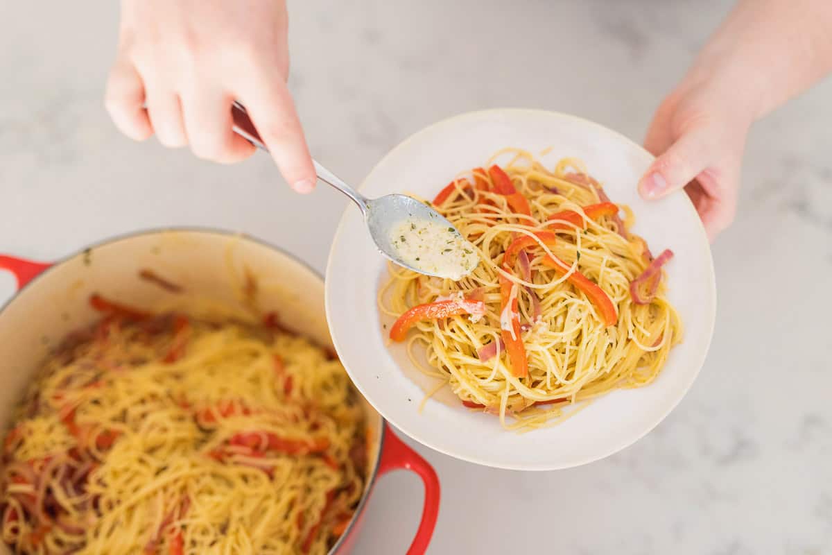 This chicken scampi recipe is to die for. Angel hair pasta covered in a creamy garlic sauce with caramelized onions and bell peppers & topped with chicken. 