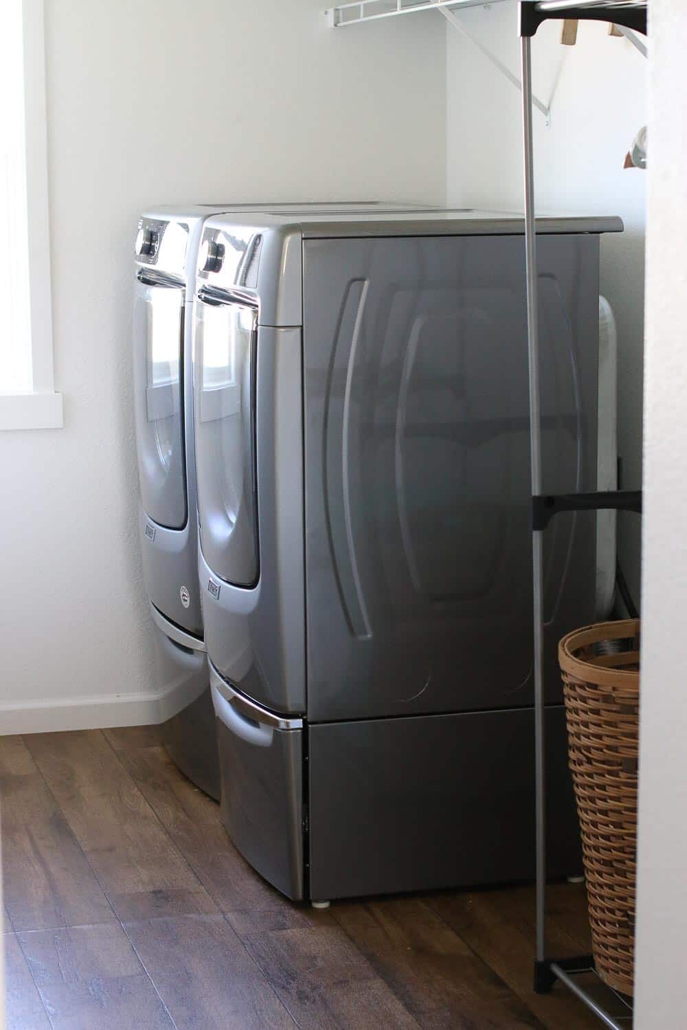 Maytag washer and dryer in a room with wood flooring.