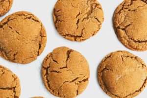 Chewy ginger molasses cookies on a white surface.